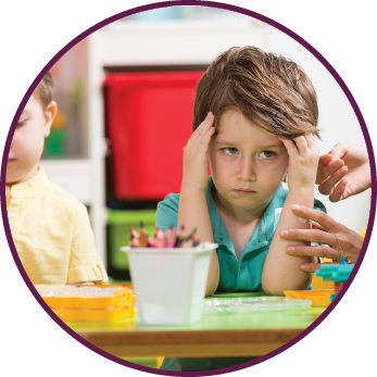 Angry little boy in classroom 