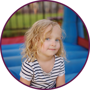 Curly little girl having fun in leisure center for kids  Child sport activity on outdoor playground  Toddler girl playing in kindergarten or entertainment centre  Kid jumping on trampoline 