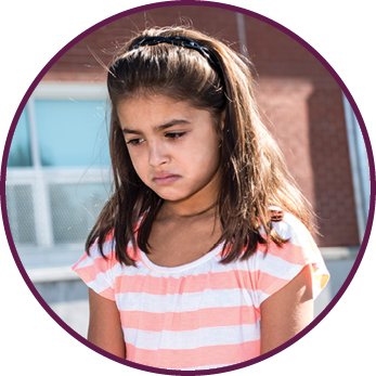 A teacher consoling girl on a schoolyards
